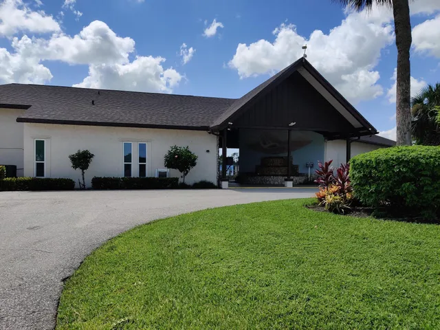 a group of people sitting in backyard of the house