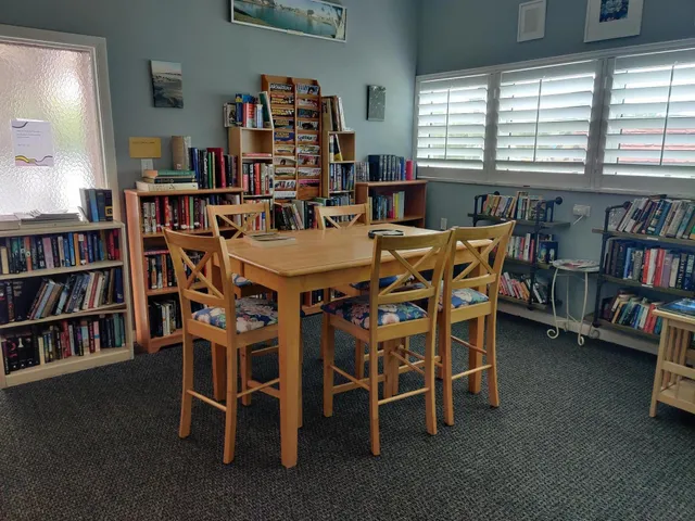 a dining room with furniture and a book shelf