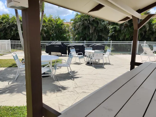 a view of roof deck with chair and tables