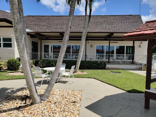 a view of a house with backyard porch and sitting area