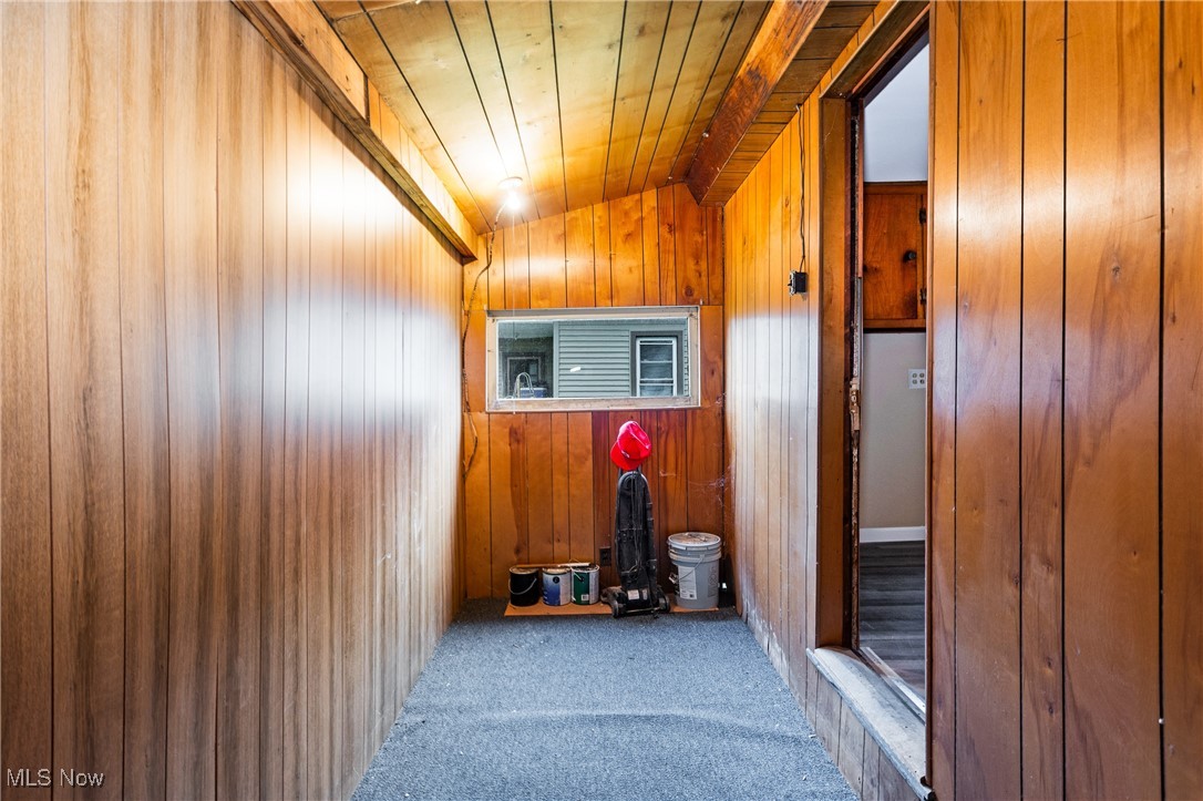 7529 State Line Burghill, OH 44404 - Photo 10 of 23 Corridor with carpet, wooden walls, and wood ceiling