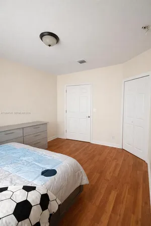 a bedroom with a bed and a dresser