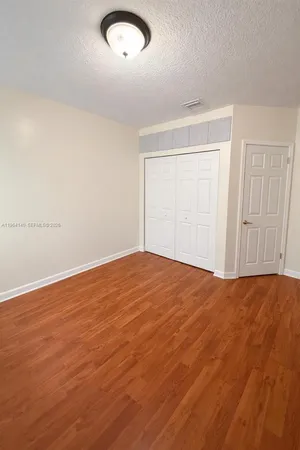 an empty room with wooden floor