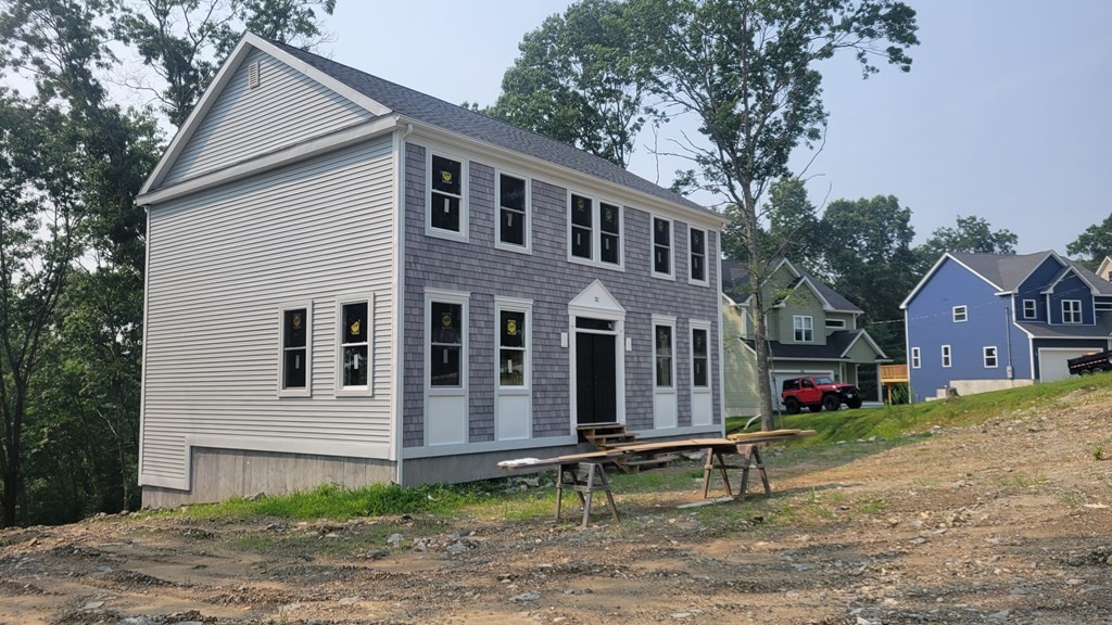 32 Brookside Avenue Webster, MA 01570 - Photo 2 of 6 a view of brick house with large windows and a small yard