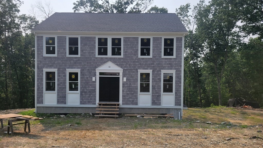 32 Brookside Avenue Webster, MA 01570 - Photo 3 of 6 a front view of a house with a garden