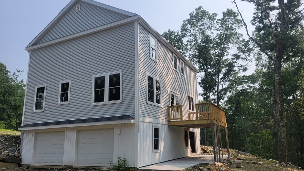 32 Brookside Avenue Webster, MA 01570 - Photo 5 of 6 a front view of small house with yard