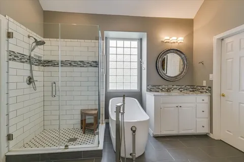 a bathroom with a granite countertop sink toilet and shower