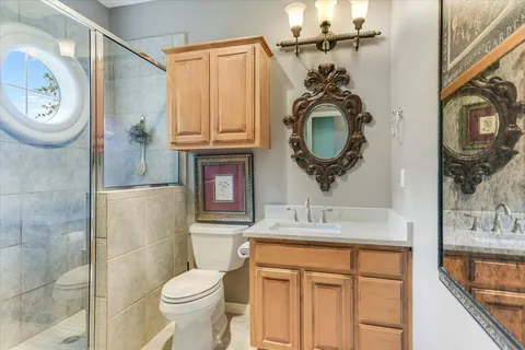 a bathroom with a sink a toilet and mirror