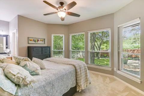 a bedroom with a large bed and a window