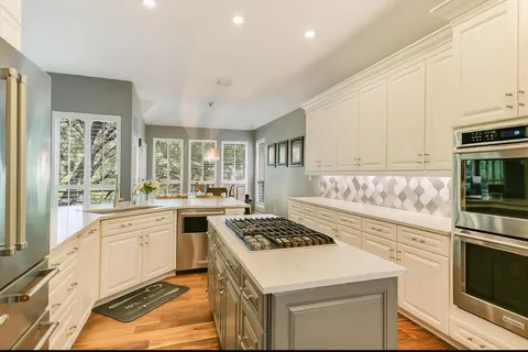 a kitchen with a stove a sink and a refrigerator