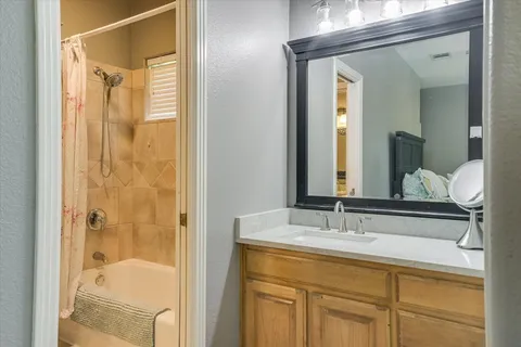 a bathroom with a shower sink and mirror