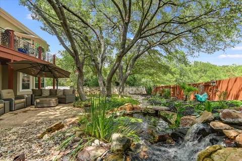 a view of a house with a yard and sitting area