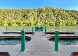 a view of a lake with a bench and wooden floor
