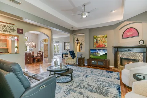 a living room with furniture a flat screen tv and a fireplace