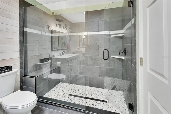 a bathroom with a toilet and a shower