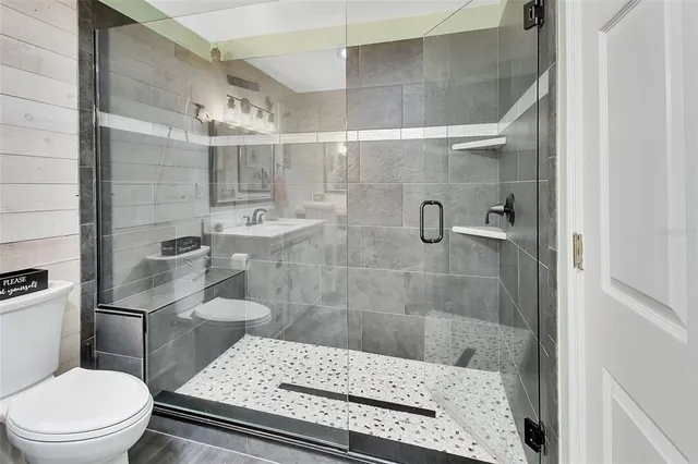 a bathroom with a toilet and a shower