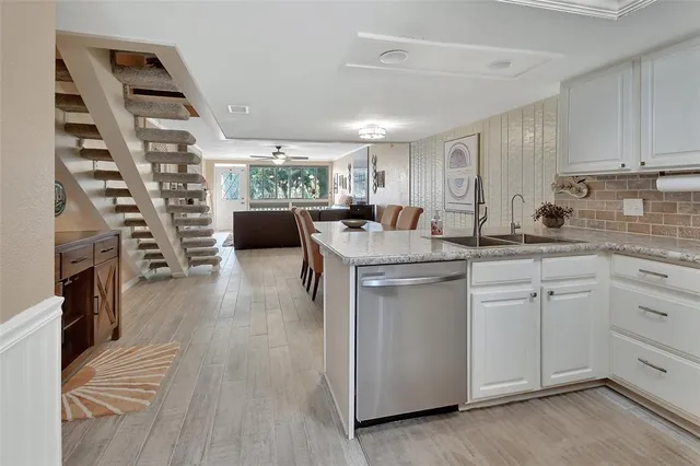 a kitchen with a sink stove and cabinets