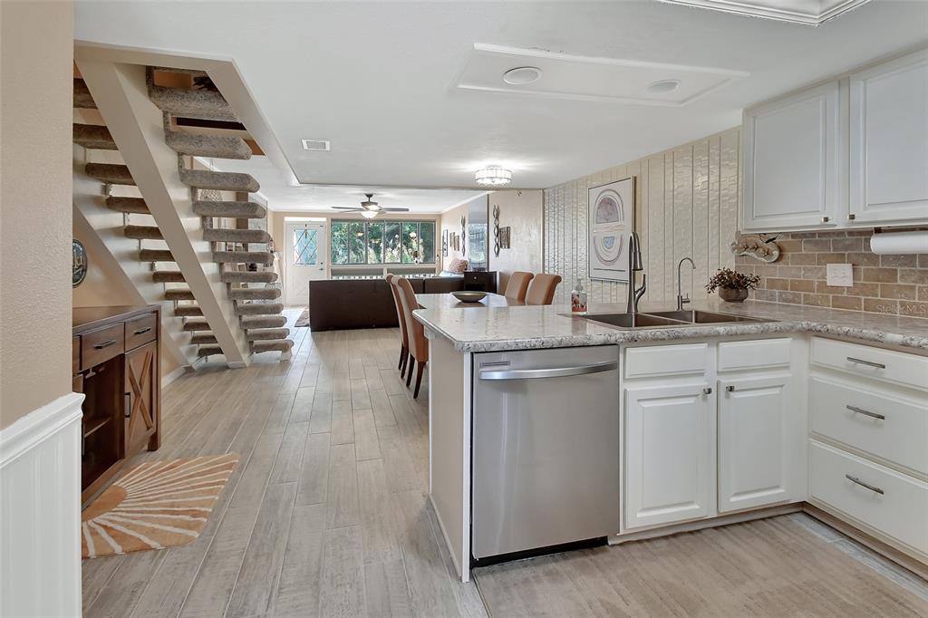 2329 River Ridge Road, Unit 4 DeLand, FL 32720 - Photo 5 of 23 a kitchen with a sink stove and cabinets