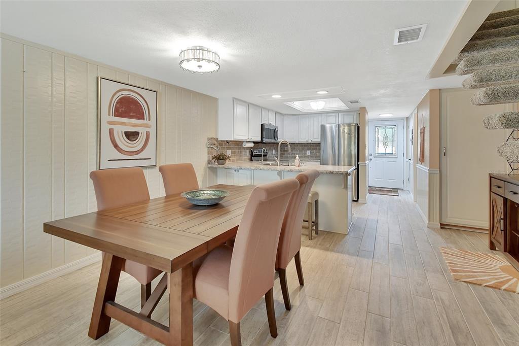 2329 River Ridge Road, Unit 4 DeLand, FL 32720 - Photo 8 of 23 a view of kitchen and dining area with furniture