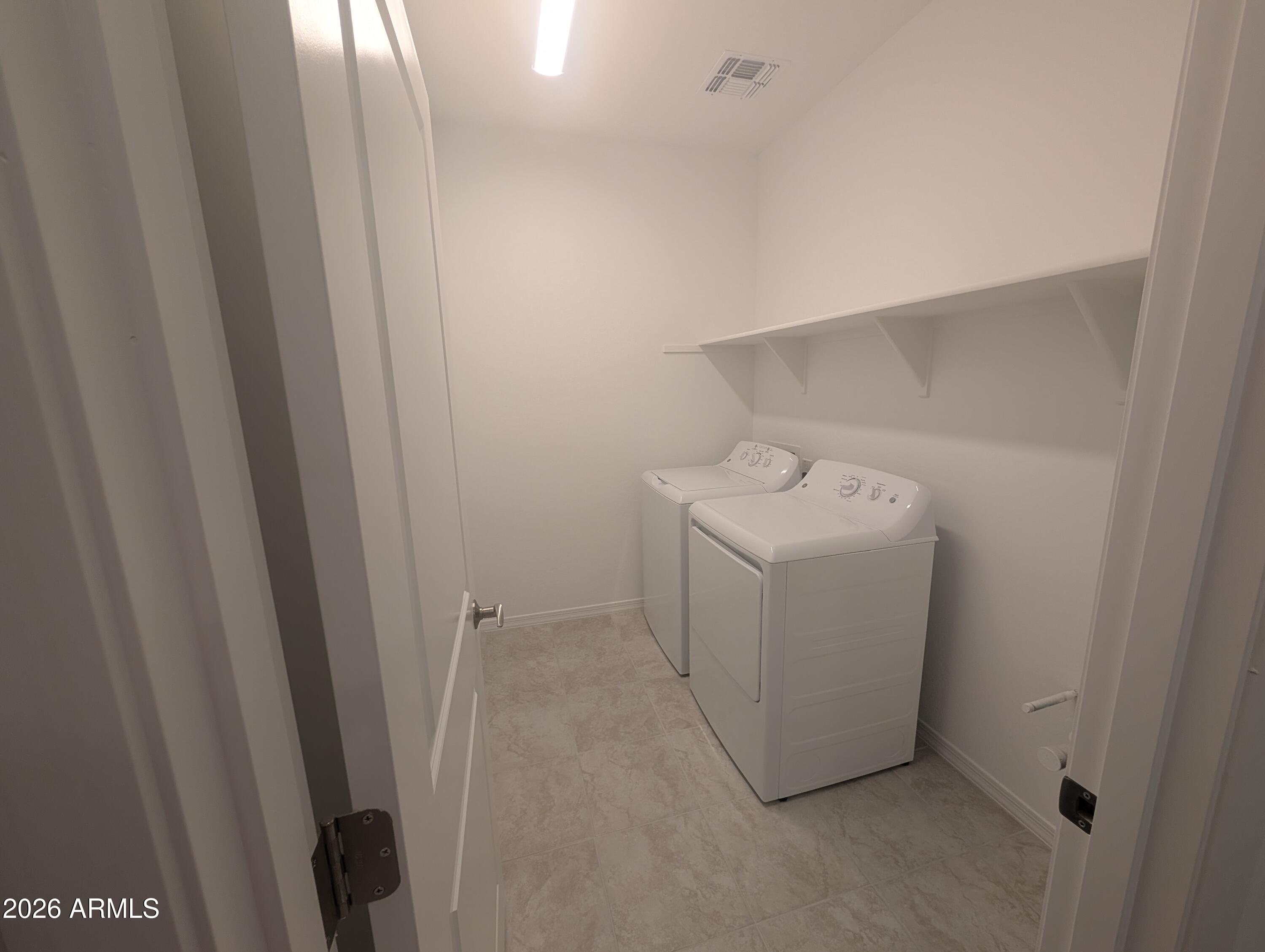 16340 South 182nd Drive Goodyear, AZ 85338 - Photo 11 of 38 a utility room with dryer and washer