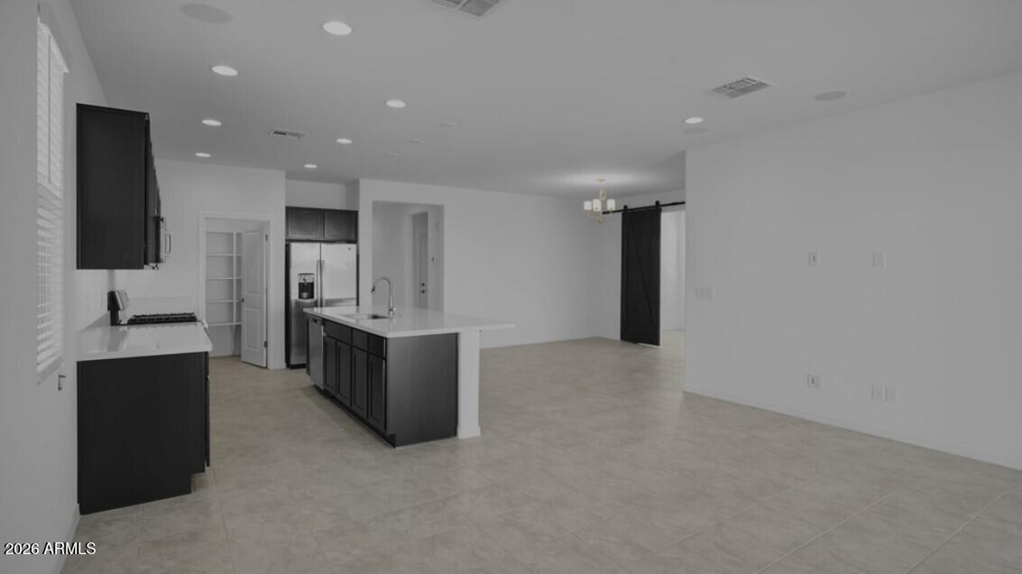 16340 South 182nd Drive Goodyear, AZ 85338 - Photo 23 of 38 a large kitchen with a large counter top stainless steel appliances and cabinets