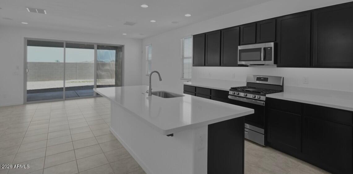 16340 South 182nd Drive Goodyear, AZ 85338 - Photo 28 of 38 a kitchen with a sink a stove and cabinets