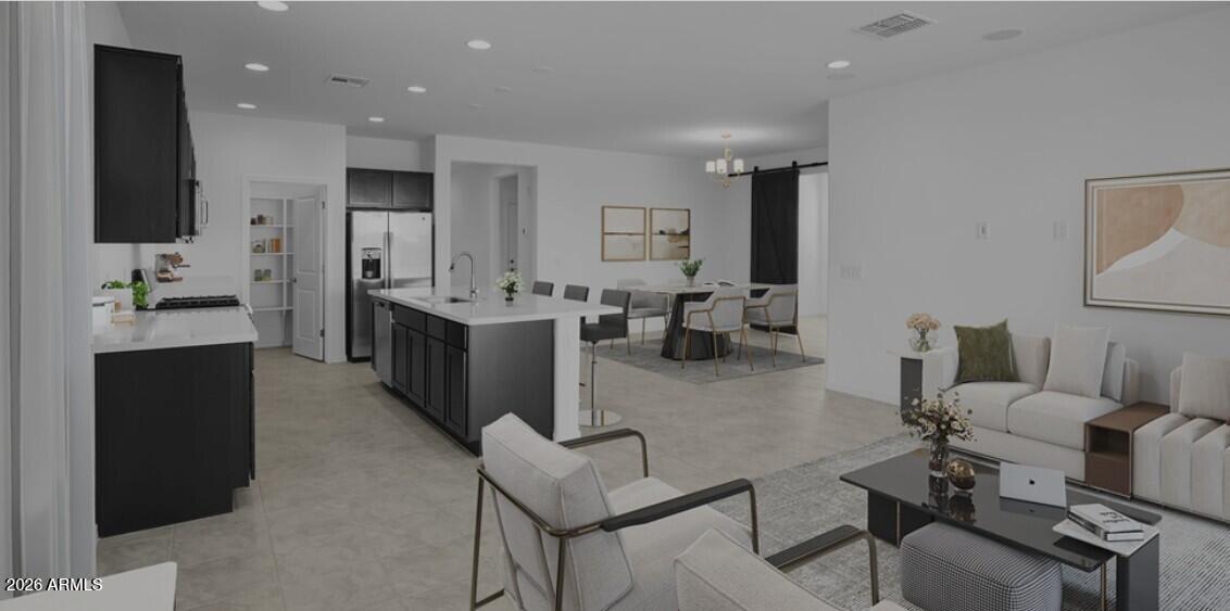 16340 South 182nd Drive Goodyear, AZ 85338 - Photo 3 of 38 a living room with furniture and a flat screen tv