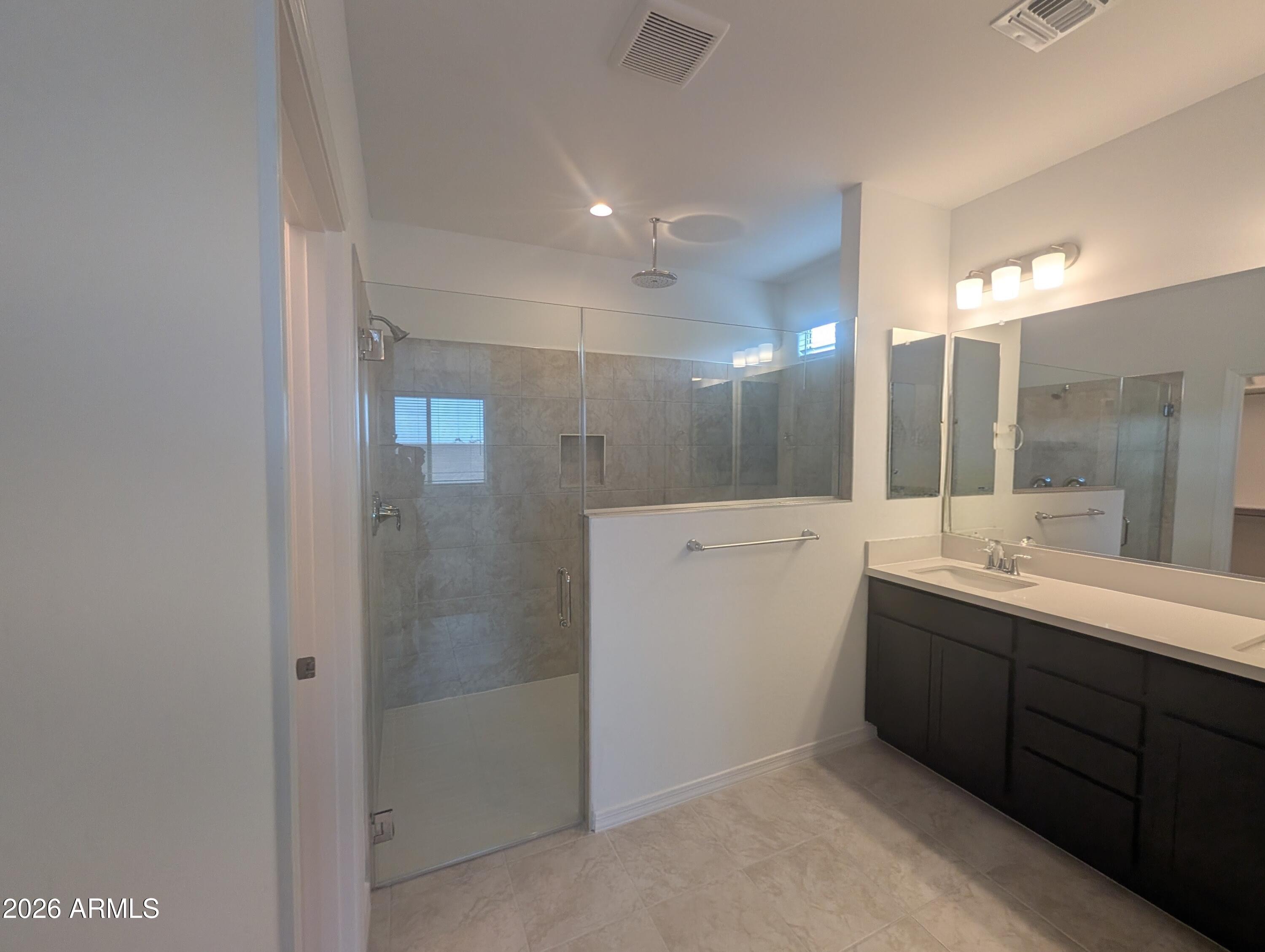 16340 South 182nd Drive Goodyear, AZ 85338 - Photo 8 of 38 a bathroom with a double vanity sink and mirror