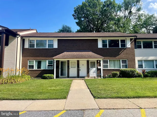 front view of brick house with a yard