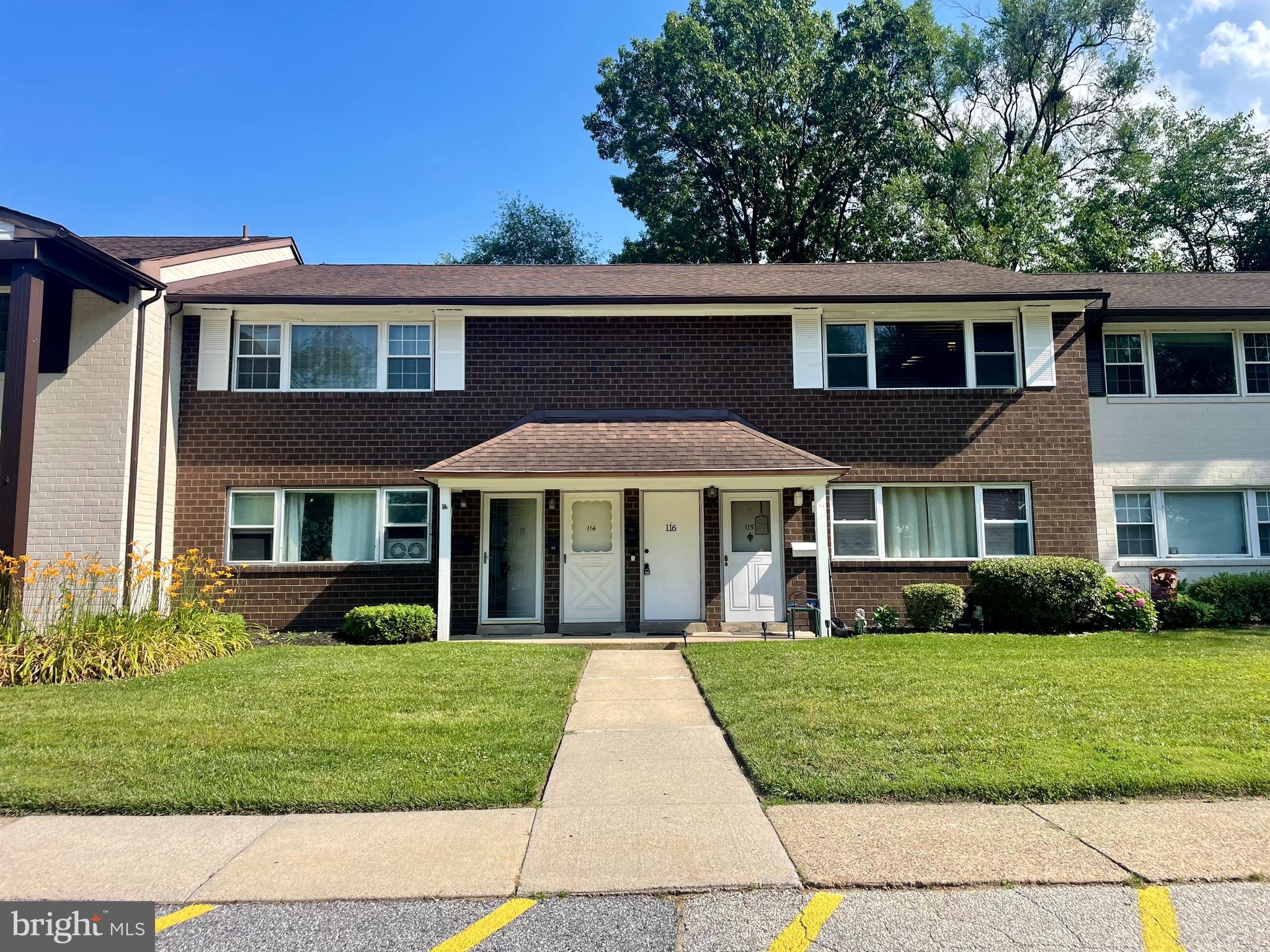 front view of brick house with a yard