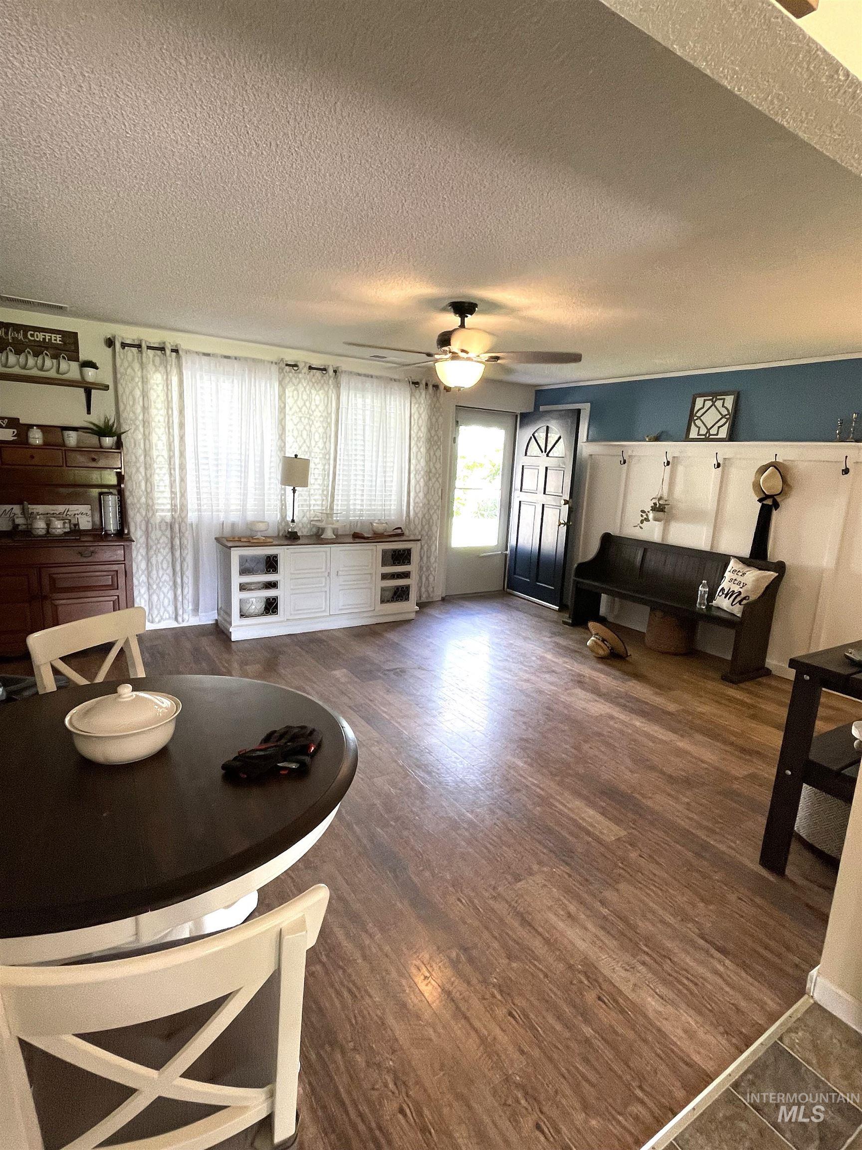 12733 South Five Mile Road Kuna, ID 83634 - Photo 3 of 21 Living area featuring a textured ceiling and dark wood-style flooring