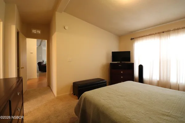 a bedroom with a bed and a television