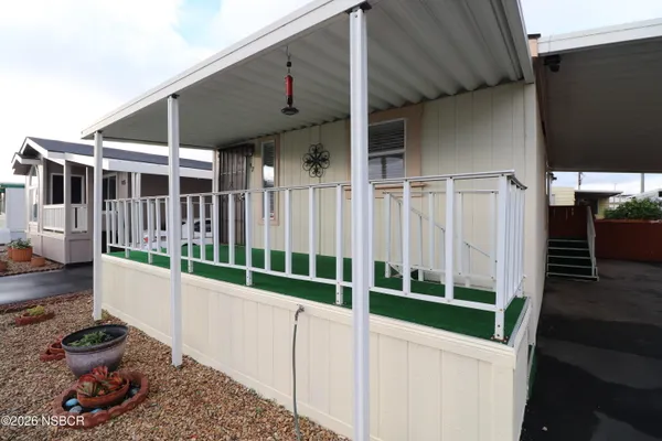 a view of a house with wooden fence