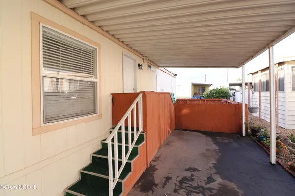 a view of staircase with wooden floor and windows