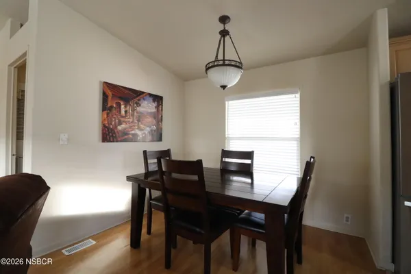 a view of a dining room with furniture window and wooden floor