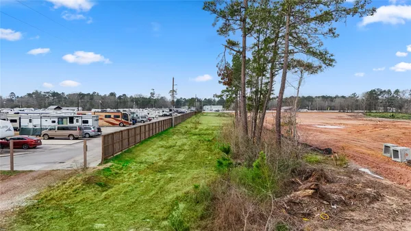 a view of a yard with wooden fence