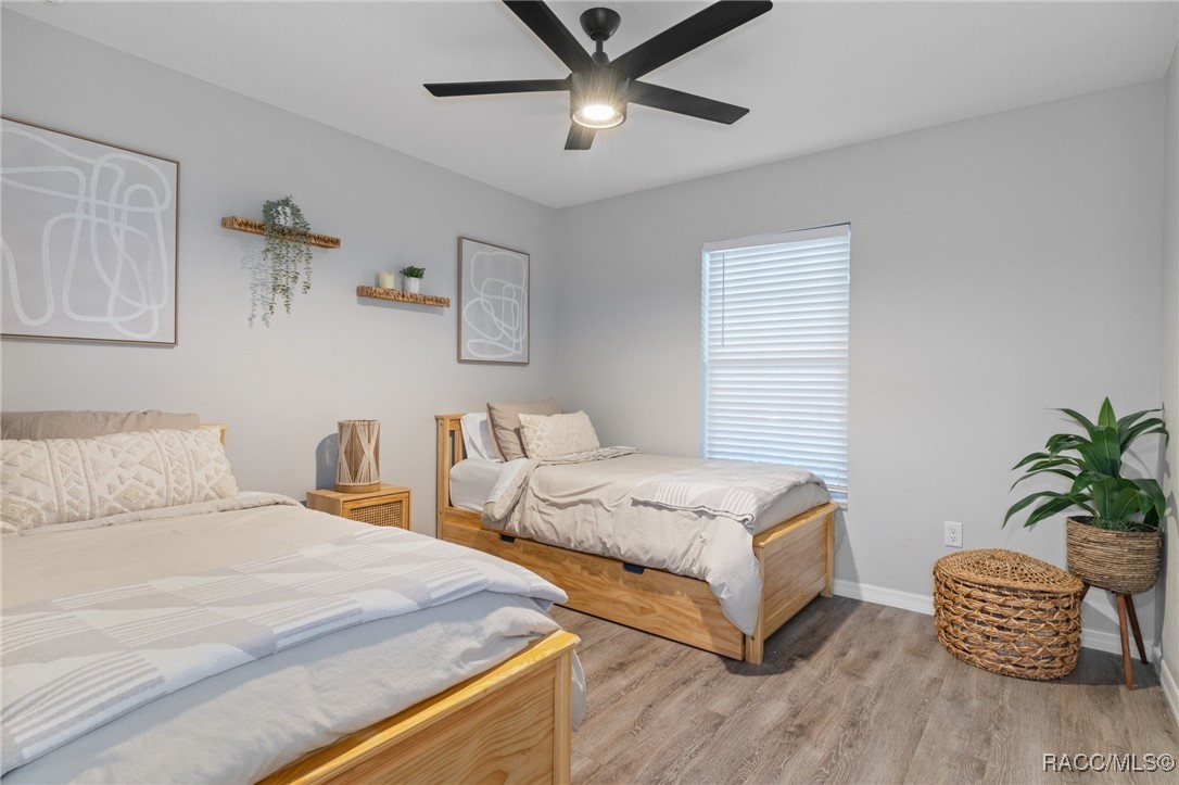4865 South Tromp Loop Homosassa, FL 34448 - Photo 15 of 30 a bedroom with two beds and potted plant