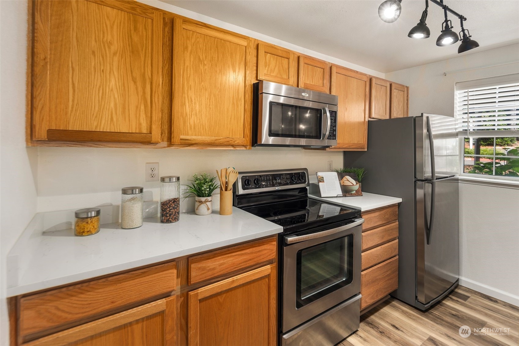 580 Front Street South, Unit C113 Issaquah, WA 98027 - Photo 12 of 31 a kitchen with stainless steel appliances granite countertop a refrigerator stove top oven a sink and dishwasher