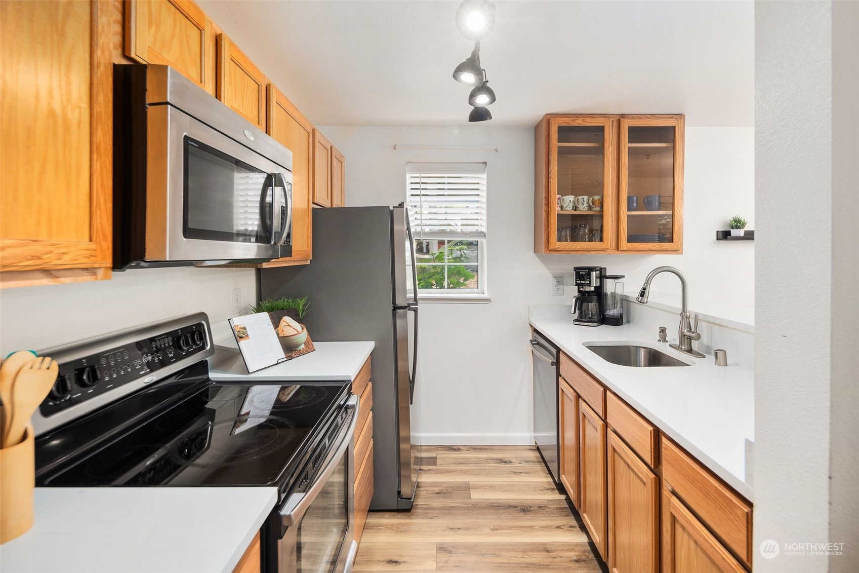 580 Front Street South, Unit C113 Issaquah, WA 98027 - Photo 13 of 31 a kitchen with a sink stove top oven and cabinets