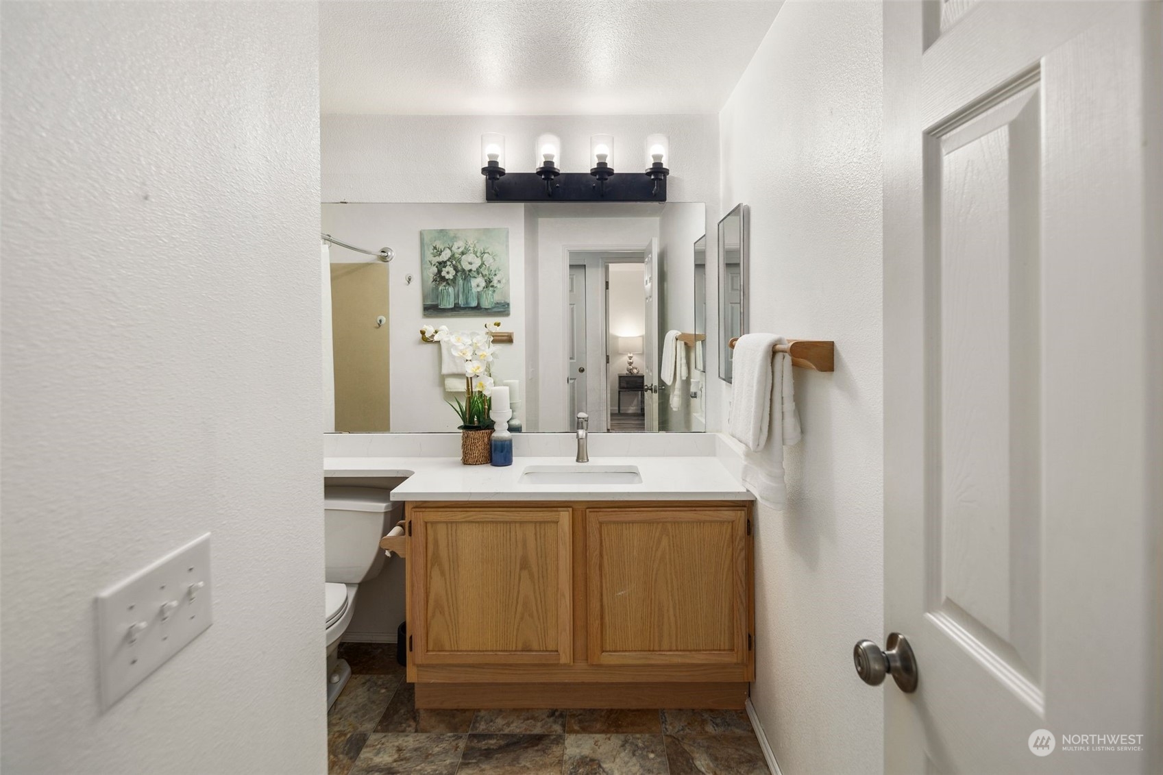 580 Front Street South, Unit C113 Issaquah, WA 98027 - Photo 24 of 31 a bathroom with a sink a mirror and a toilet