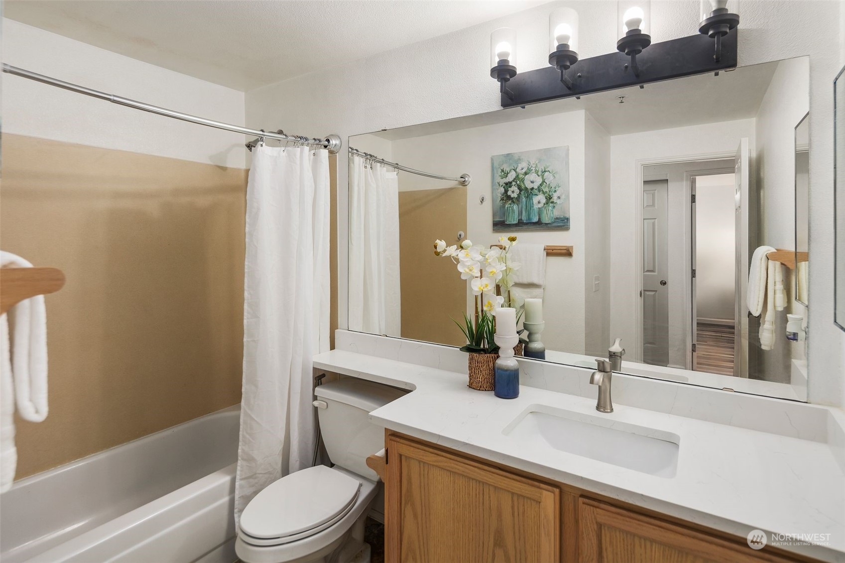580 Front Street South, Unit C113 Issaquah, WA 98027 - Photo 25 of 31 a bathroom with a sink a toilet a mirror and shower
