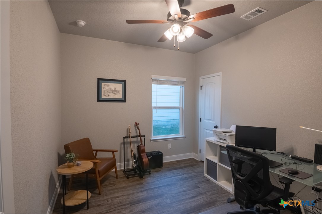 7909 McCulloch Road Temple, TX 76502 - Photo 26 of 46 a view of a workspace with furniture and wooden floor