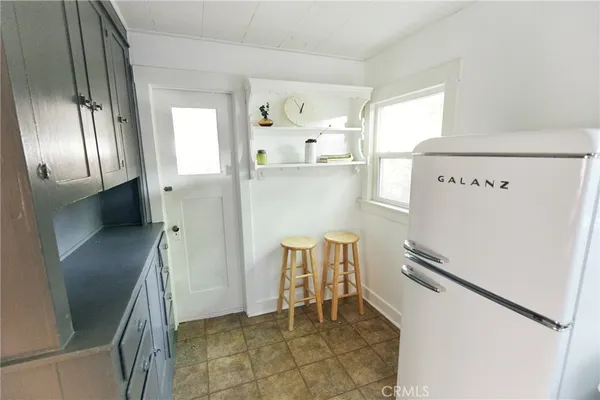 a kitchen with stainless steel appliances a refrigerator and a stove top oven