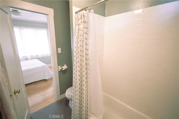 a bathroom with a shower and a toilet