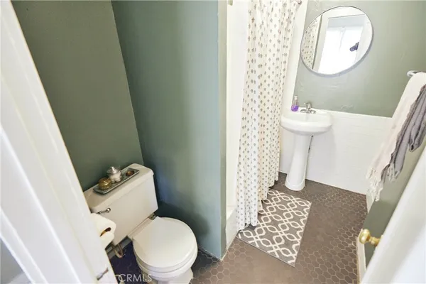 a toilet sitting in a bathroom next to a sink