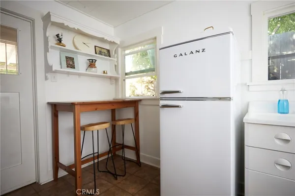 a view of kitchen with stainless steel appliances and refrigerator
