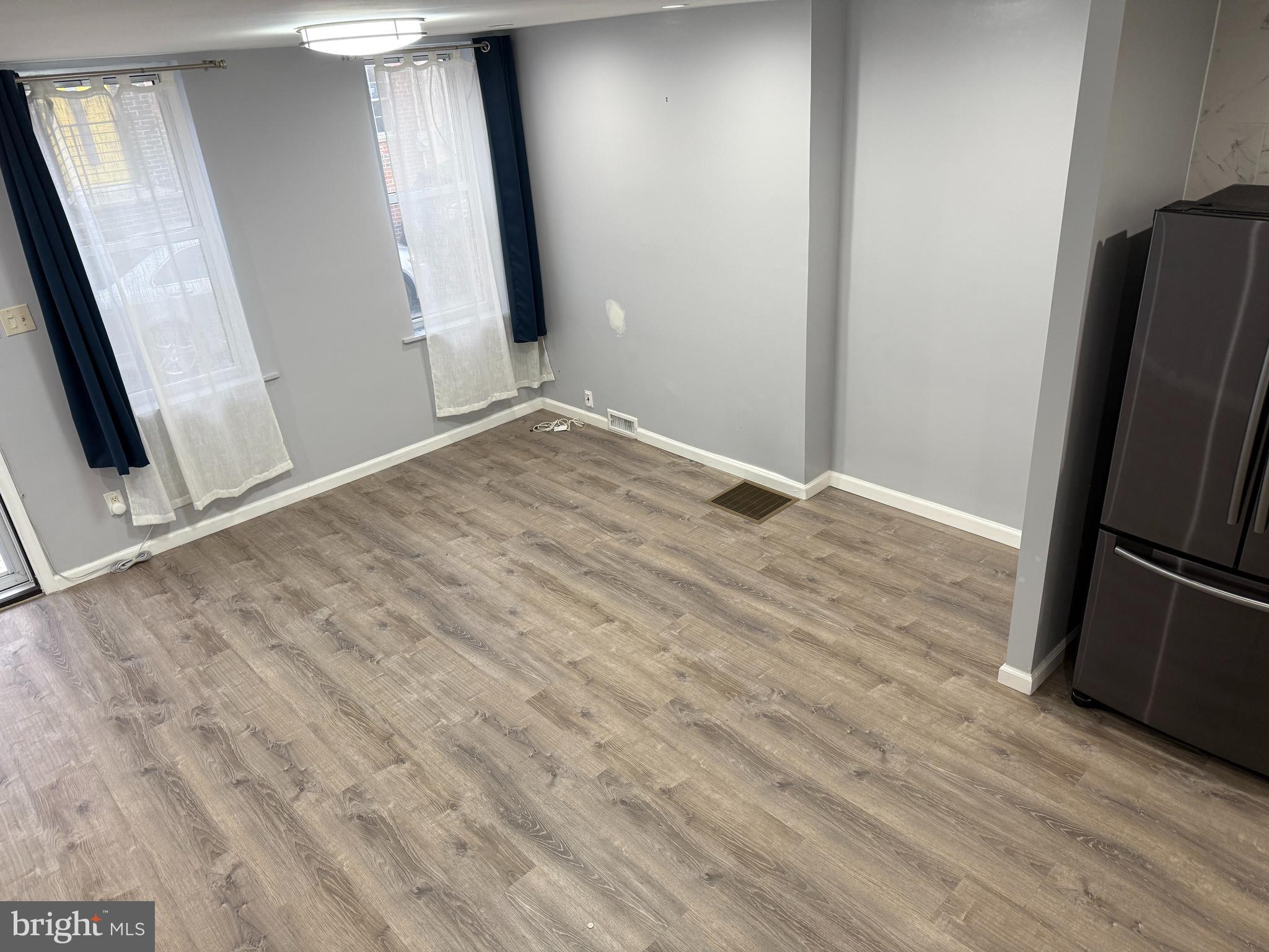 1326 South Colorado Street Philadelphia, PA 19146 - Photo 5 of 12 an empty room with wooden floor and entrance