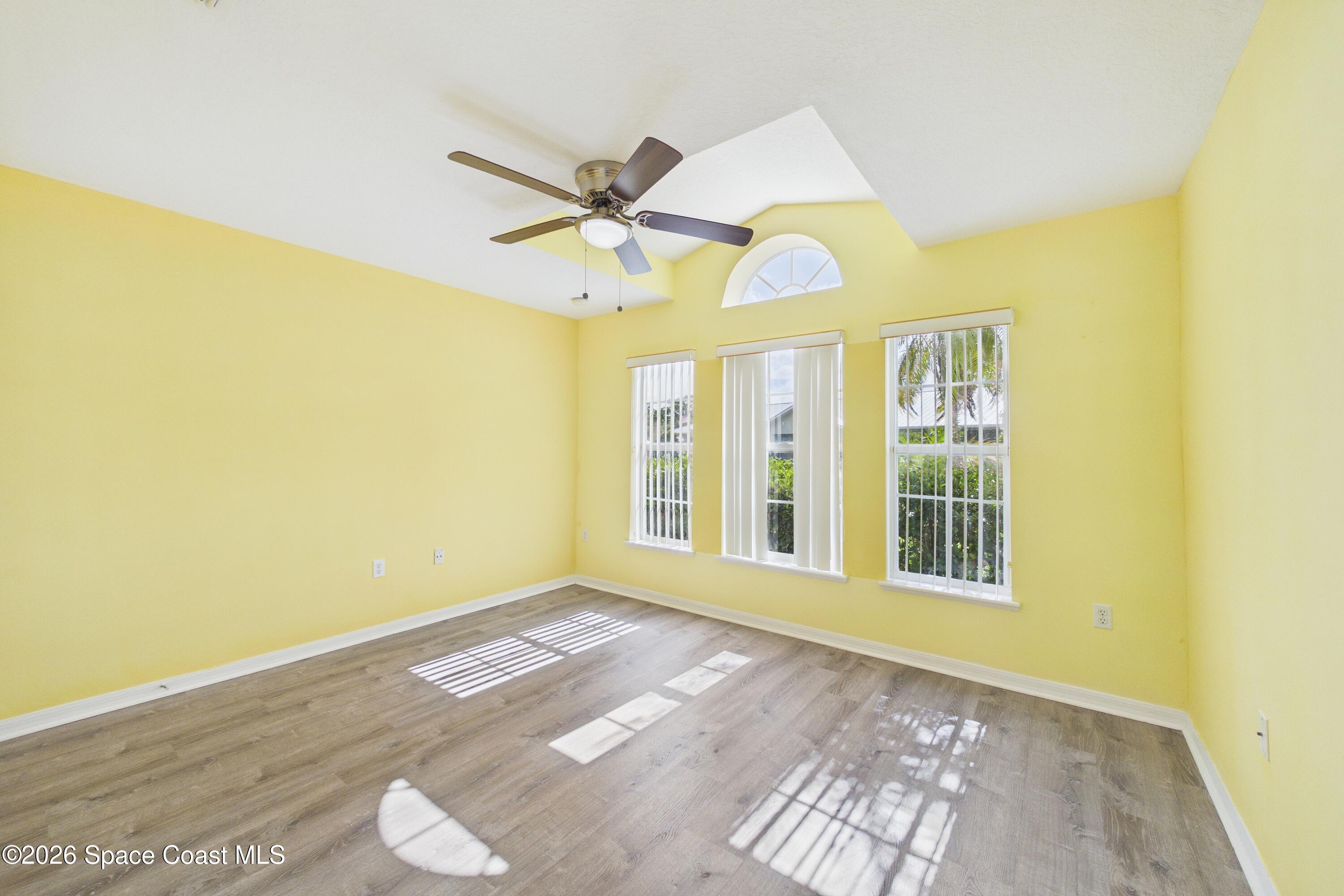 183 Stony Point Drive Sebastian, FL 32958 - Photo 11 of 27 a view of an empty room with a window and wooden floor
