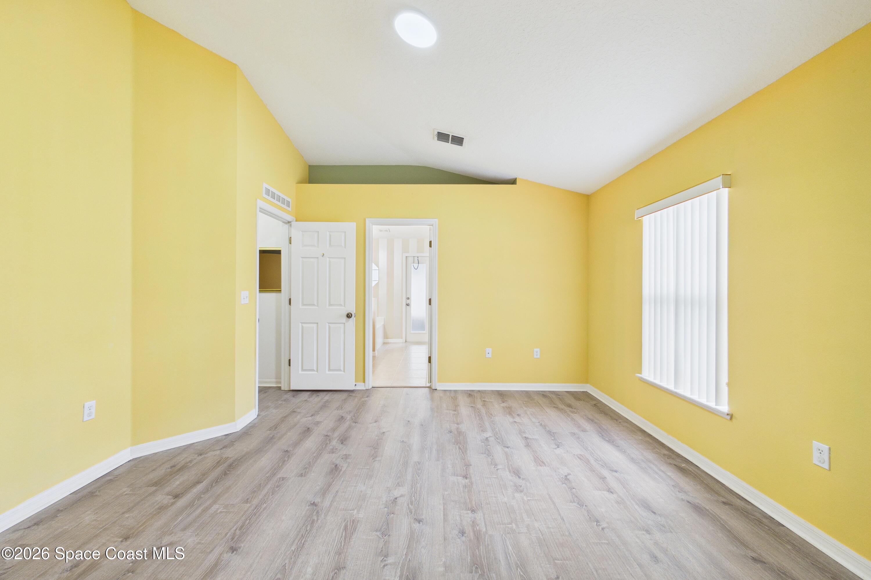 183 Stony Point Drive Sebastian, FL 32958 - Photo 16 of 27 a view of a big room with wooden floor and windows