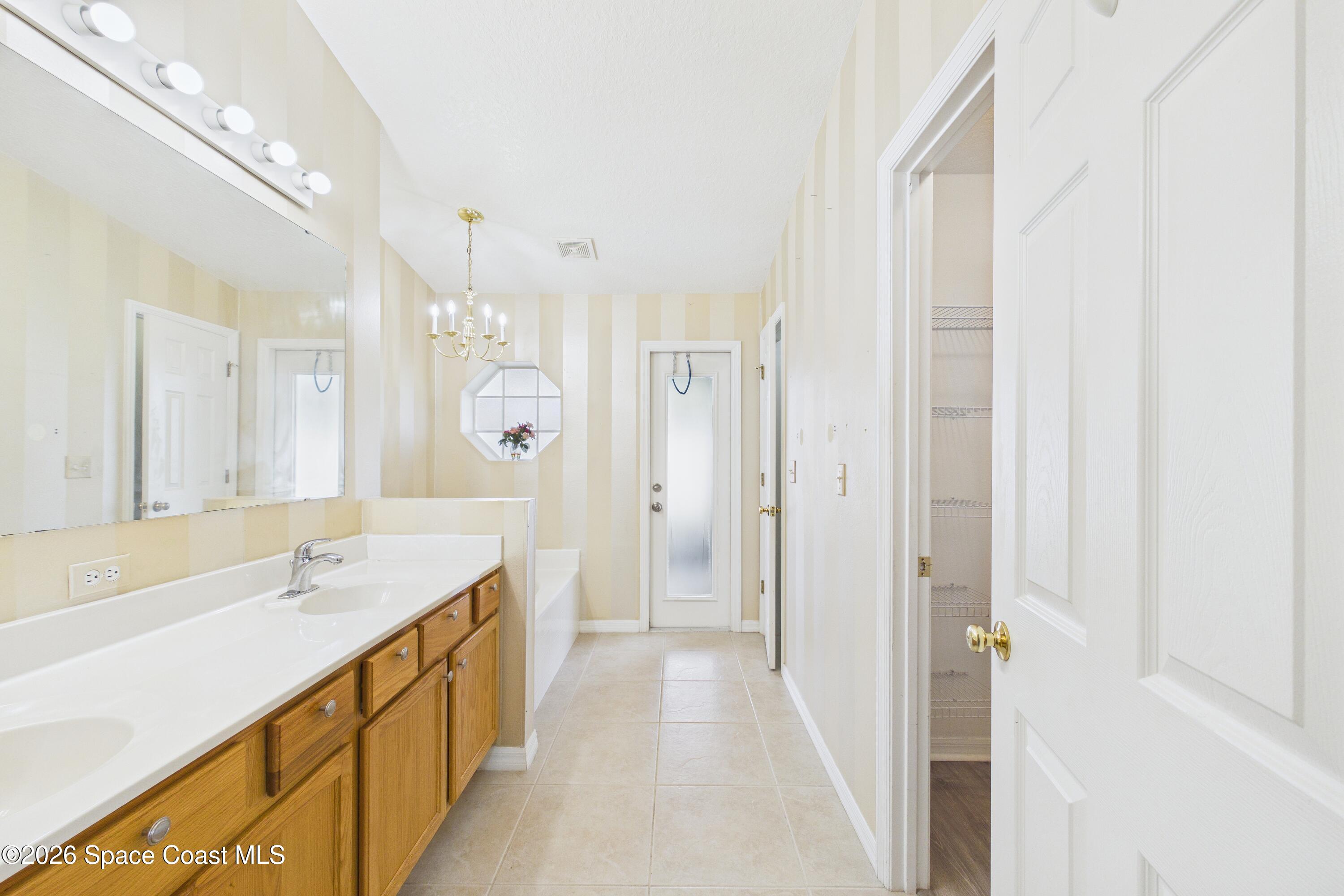 183 Stony Point Drive Sebastian, FL 32958 - Photo 17 of 27 a spacious bathroom with a shower sink and mirror